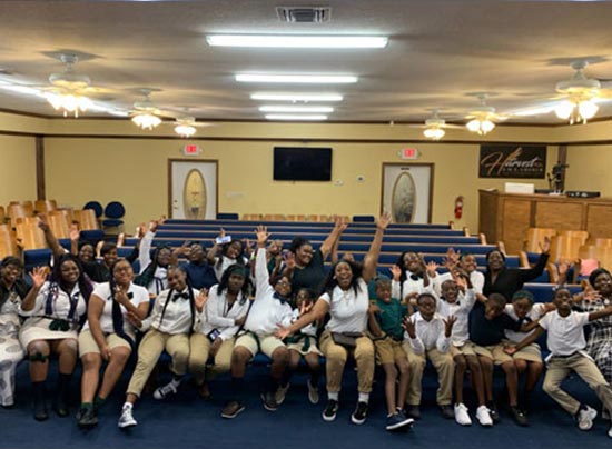 group of youth ministers dressed in white shirts and khaki pants